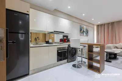 a kitchen with a black refrigerator and a table at Acacia Studio 12 in Casablanca