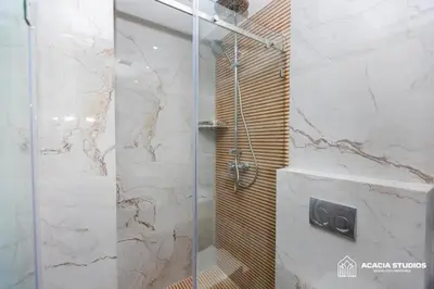 a shower with a glass door in a bathroom at Acacia Studio 13 in Casablanca
