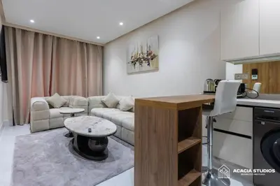 a kitchen and living room with a couch and a table at Acacia Studio 13 in Casablanca