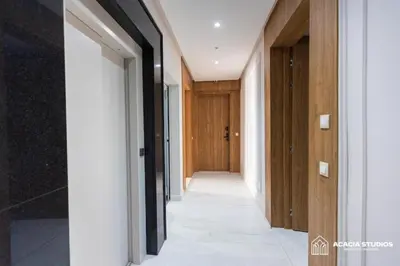 a hallway in a house with wooden doors at Acacia Studio 15 in Casablanca