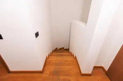 a hallway with white walls and wooden floors at Beyti in Rabat