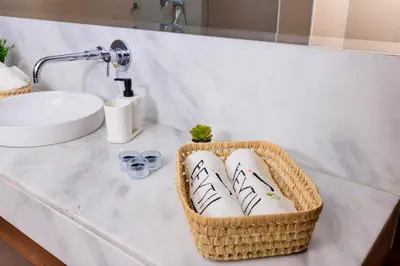 a bathroom with a basket of towels on a counter at Beyti in Rabat