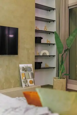 a living room with a television and a plant at Beyti in Rabat