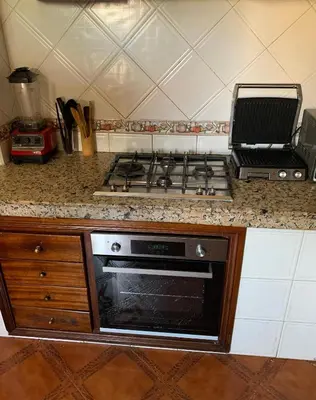 a kitchen with a stove and a counter top at Top Location Apartment City Center 1min Away From Tram Station in Casablanca