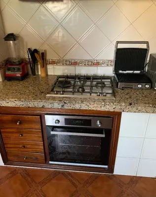 a kitchen with a stove and a counter top at Top Location Apartment City Center 1min Away From Tram Station in Casablanca