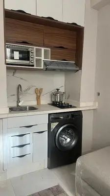 a kitchen with a washing machine and a microwave at home garden in Casablanca