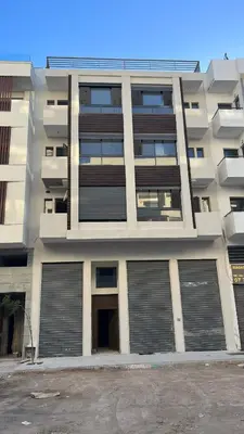 an apartment building with two garage doors at home garden in Casablanca