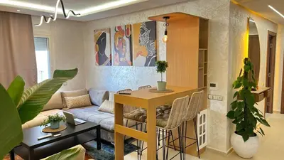 a living room with a couch and a table at N28 3 Bedrooms & Private Gym just walking to Stade Moulay Abdellah in Rabat