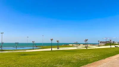a park with the beach and the ocean in the background at N28 3 Bedrooms & Private Gym just walking to Stade Moulay Abdellah in Rabat