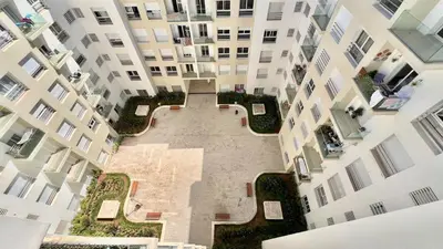 an aerial view of a courtyard in an apartment building at N28 3 Bedrooms & Private Gym just walking to Stade Moulay Abdellah in Rabat