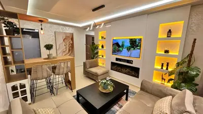 a living room with a couch and a table at N28 3 Bedrooms & Private Gym just walking to Stade Moulay Abdellah in Rabat