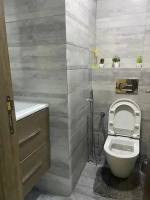 a bathroom with a toilet and a sink at Charmant appartement joyau du parc 200m plage in Mohammedia