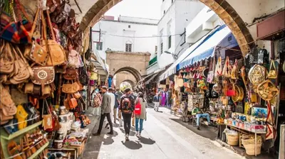 a group of people walking down a street in a market at Downtown delight studio in Casablanca