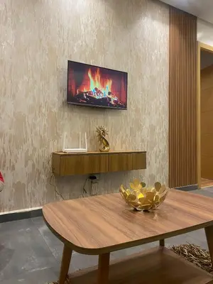 a living room with a table and a tv on a wall at Downtown delight studio in Casablanca