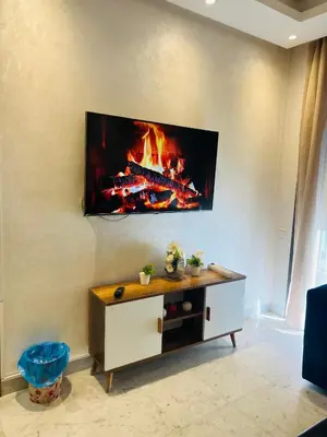 a living room with a fire on the wall at Ataraxia in Casablanca