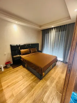 a bedroom with a large bed and a wooden floor at Ataraxia in Casablanca