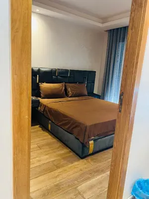 a bedroom with a bed with a wooden floor at Ataraxia in Casablanca