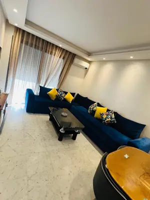 a living room with a blue couch and a table at Ataraxia in Casablanca