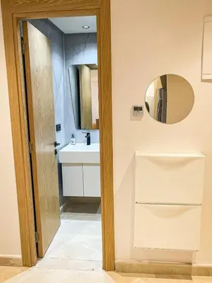 a bathroom with a sink and a mirror at Residence La Reine II 24H Reception Cosy & Central Apartment 1 Minute Near To MOHAMMED V SPORTS COMPLEX 5 Min By Car To Ain Diab Corniche With Optical Fiber Wifi Casablanca in Casablanca