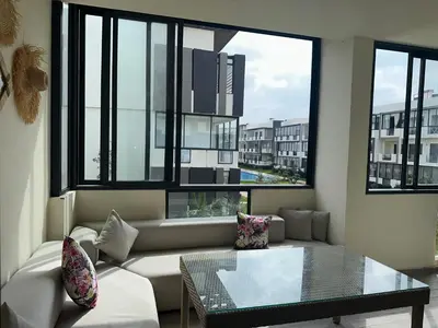 a living room with a couch and a glass table at Appartement Les Crêtes in Casablanca