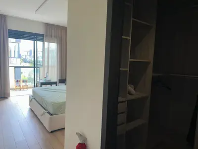 a bedroom with a bed and a book shelf at Appartement Les Crêtes in Casablanca