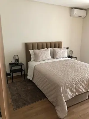 a bedroom with a large bed and two tables at L'oasis - by Mi-haven in Casablanca