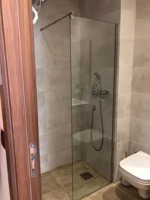a glass shower with a toilet in a bathroom at L'oasis - by Mi-haven in Casablanca