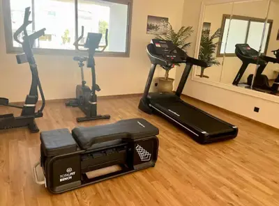 a gym with treadmills and exercise bikes in a room at L'oasis - by Mi-haven in Casablanca