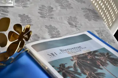 a book sitting on a table next to a pair of glasses at Le Palmier - By Mi-Haven in Casablanca