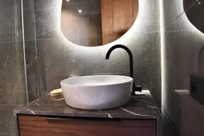 a bathroom with a sink and a large mirror at Le Palmier - By Mi-Haven in Casablanca
