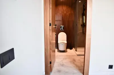 a bathroom with a toilet through a doorway at Le Palmier - By Mi-Haven in Casablanca