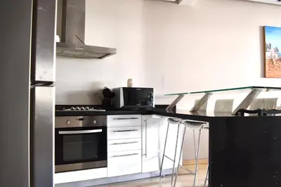 a kitchen with a stove and a microwave at Le Sacré-Coeur - by Mi-Haven in Casablanca