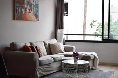 a living room with a couch and a table at Le Sacré-Coeur - by Mi-Haven in Casablanca