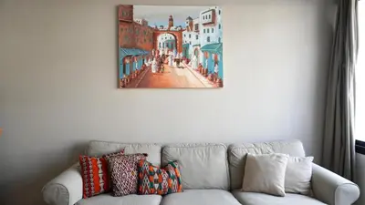 a painting on a wall above a white couch at Le Sacré-Coeur - by Mi-Haven in Casablanca