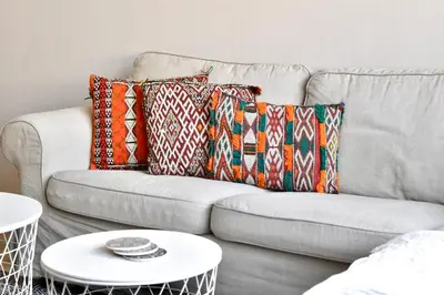 a couch with pillows on it with a white table at Le Sacré-Coeur - by Mi-Haven in Casablanca