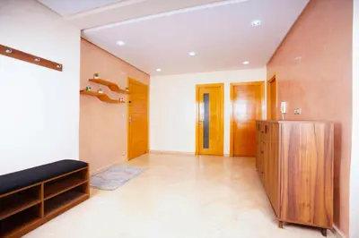 a large room with wooden doors and a hallway at apartment au coeur de Casablanca in Casablanca