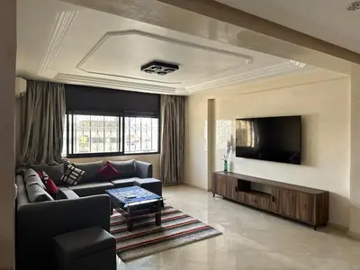 a living room with a couch and a flat screen tv at apartment au coeur de Casablanca in Casablanca
