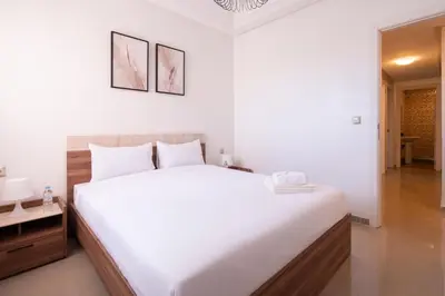 a bedroom with a large white bed in a room at Appartement Premium avec Piscine in Mohammedia