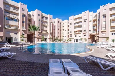 a large swimming pool in front of some buildings at Appartement Premium avec Piscine in Mohammedia