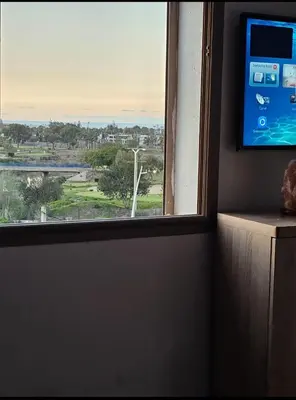 a window with a view of a golf course at Bouznika rabat in Bouznika