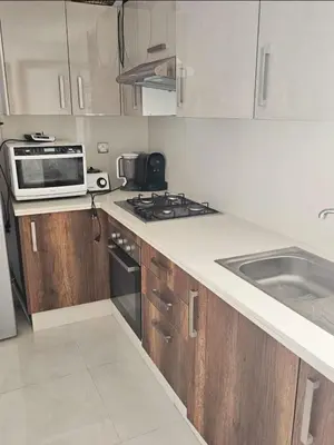 a kitchen with a stove and a microwave at Bouznika rabat in Bouznika