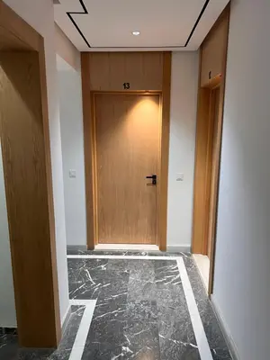 a hallway with a wooden door in a building at Studio de la perle in Casablanca