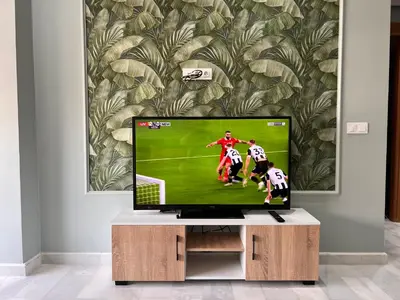 a tv in a living room with a soccer game on it at Studio de la perle in Casablanca