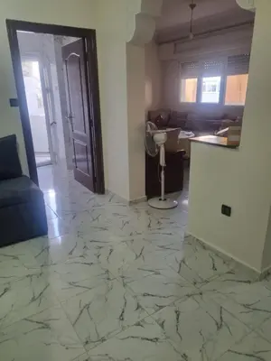 a living room with a marble floor and a door at Bayt El Fath in Casablanca