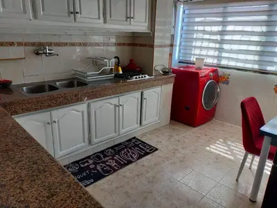 a kitchen with a sink and a washing machine at Perle de rabat in Rabat