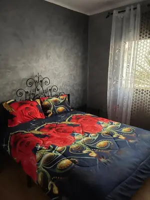 a bedroom with a bed with a red and blue blanket at Perle de rabat in Rabat
