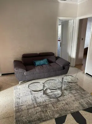 a living room with a couch and two glass tables at Perle de rabat in Rabat