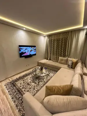 a living room with a couch and a flat screen tv at Studio proche clinique akdital ain sebaa in Casablanca