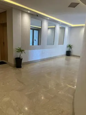 a large empty room with two potted plants in it at Studio proche clinique akdital ain sebaa in Casablanca