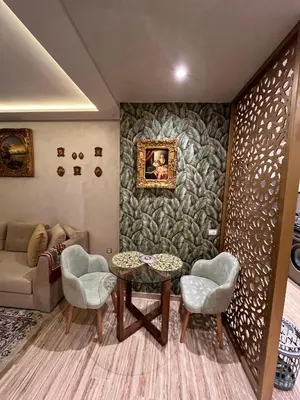 a living room with a table and chairs and a couch at Studio proche clinique akdital ain sebaa in Casablanca